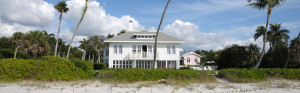 Photo of white 2 story house on beach in Sanibel Island, FL.