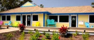 SanCap Gateway Realty office front with brightly colored yellow and blue accents. 